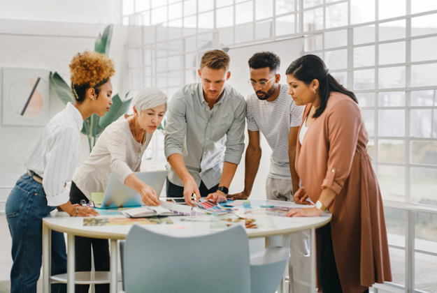 A group of employees gathering around a table