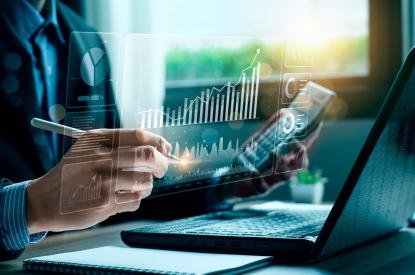 A person reviews their portfolio at their desk on their phone