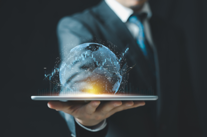 Person holding tablet, globe emerging 