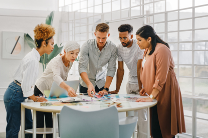 A group of employees gathering around a table